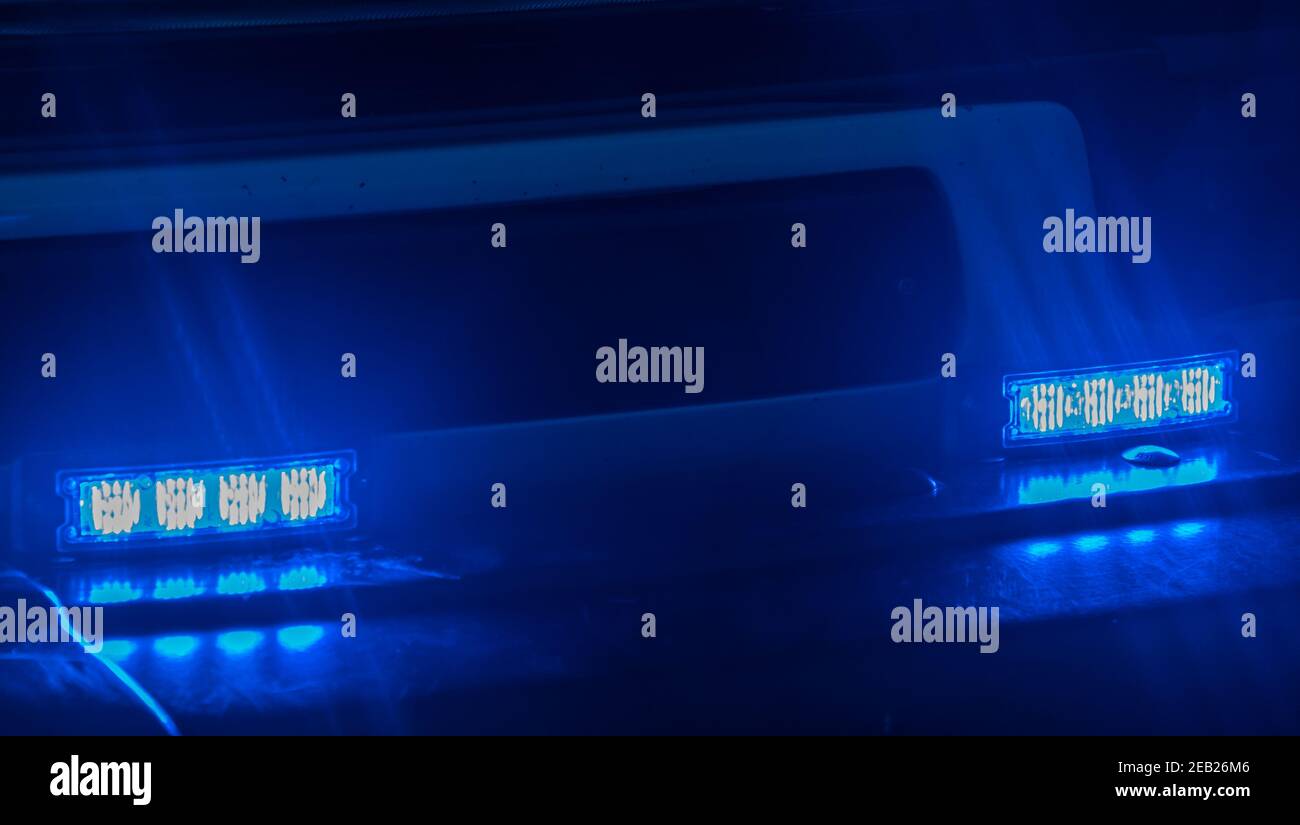 Blue blinking lights of an emergency vehicle Stock Photo