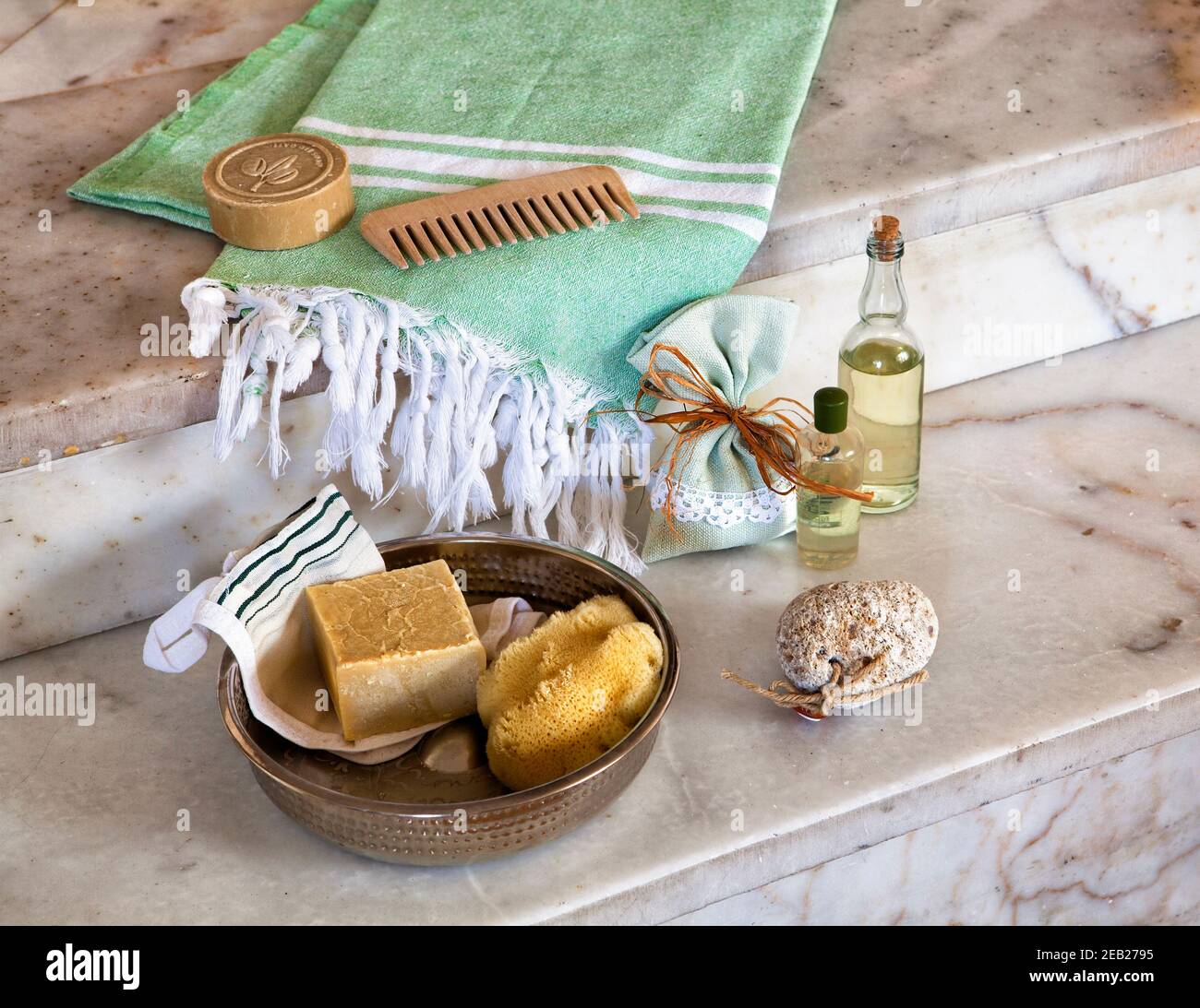 bath materials ; waist cloth, handmade soap, sponge and bath bowl on the marble texture in bathroom Stock Photo
