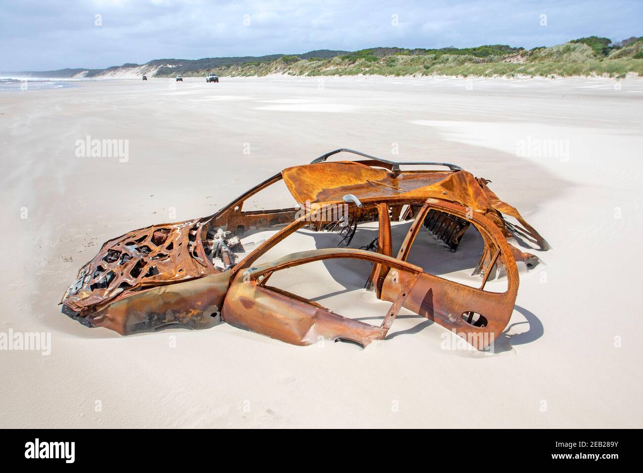 Rusted car stuck in the sand on Ocean Beach in Strahan Stock Photo Alamy