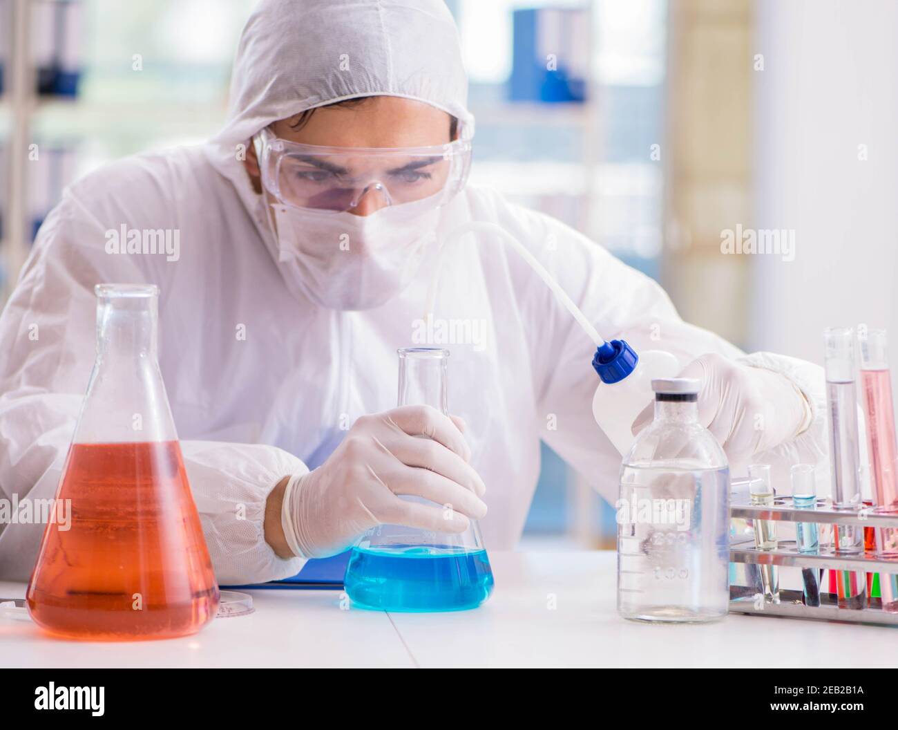 The chemist working in the laboratory with hazardous chemicals Stock