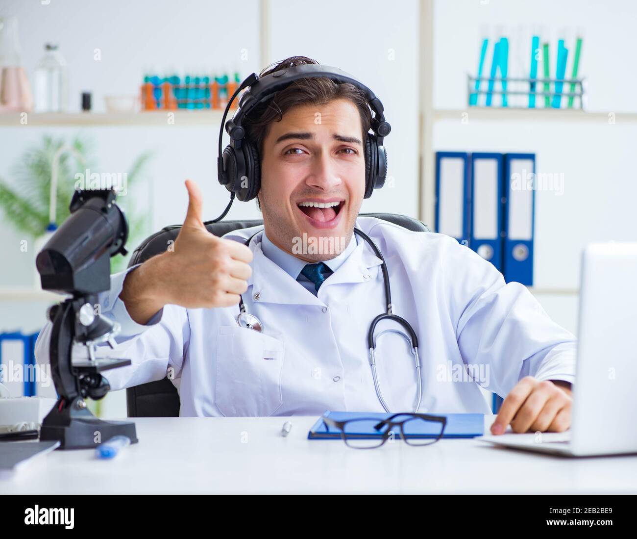 Photo Session Doctor The male doctor listening to patient during telemedicine session Stock ...