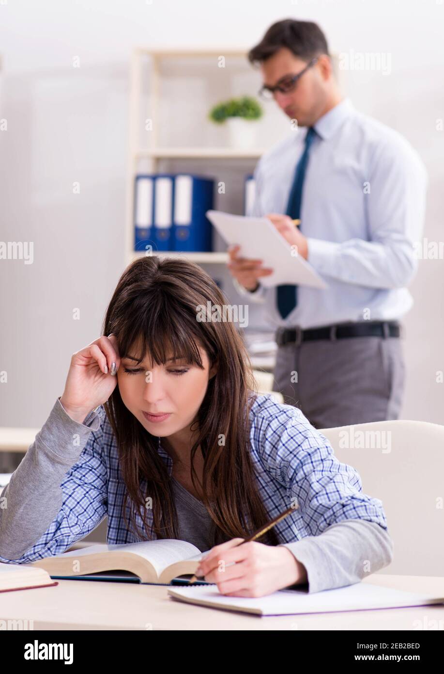 The male lecturer giving lecture to female student Stock Photo Alamy