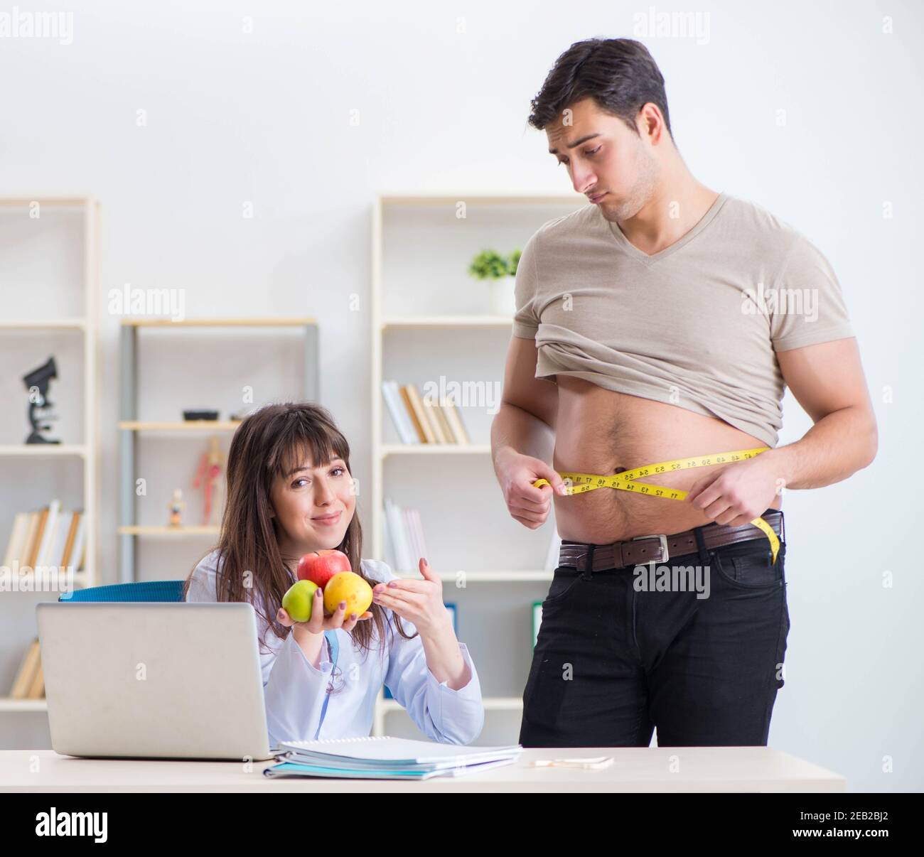 The doctor dietician giving advices to fat overweight patient Stock