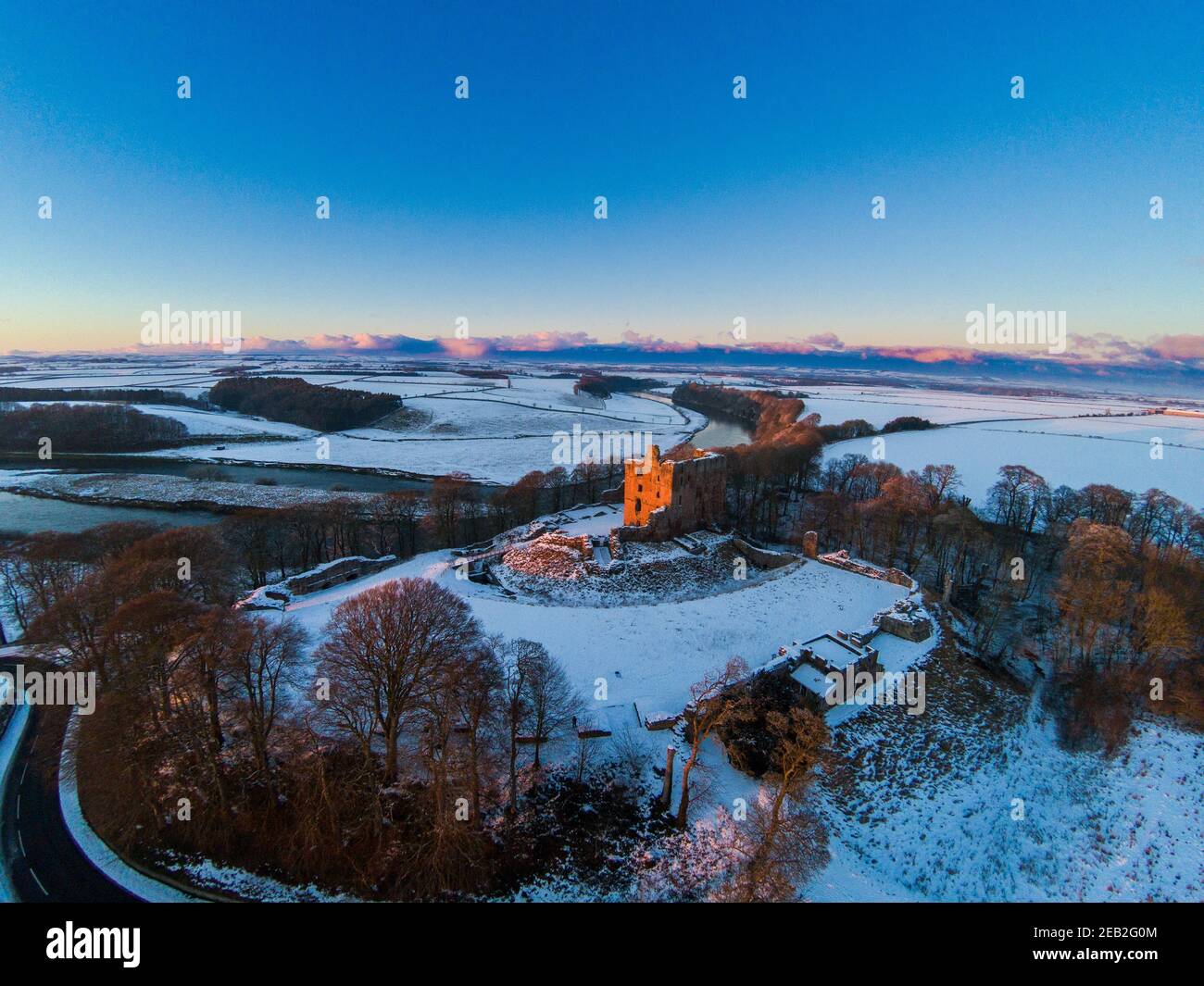 Aerial view of Norham Castle which stands guard over the River Tweed a favourite subject of Turner who attributed much of his fame to it. Stock Photo