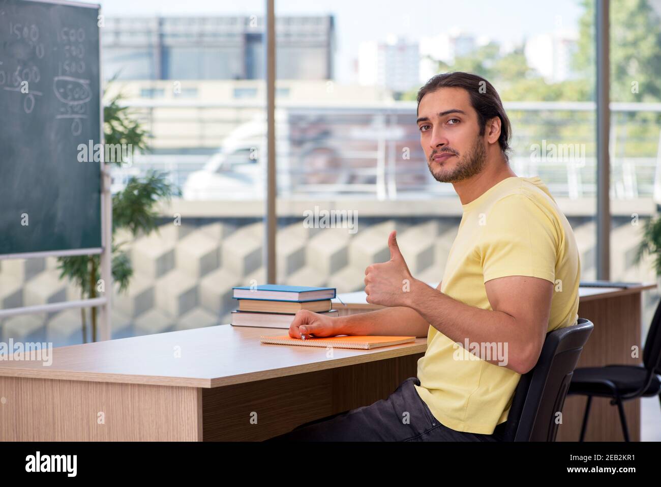 Male student sitting in the classroom Stock Photo - Alamy