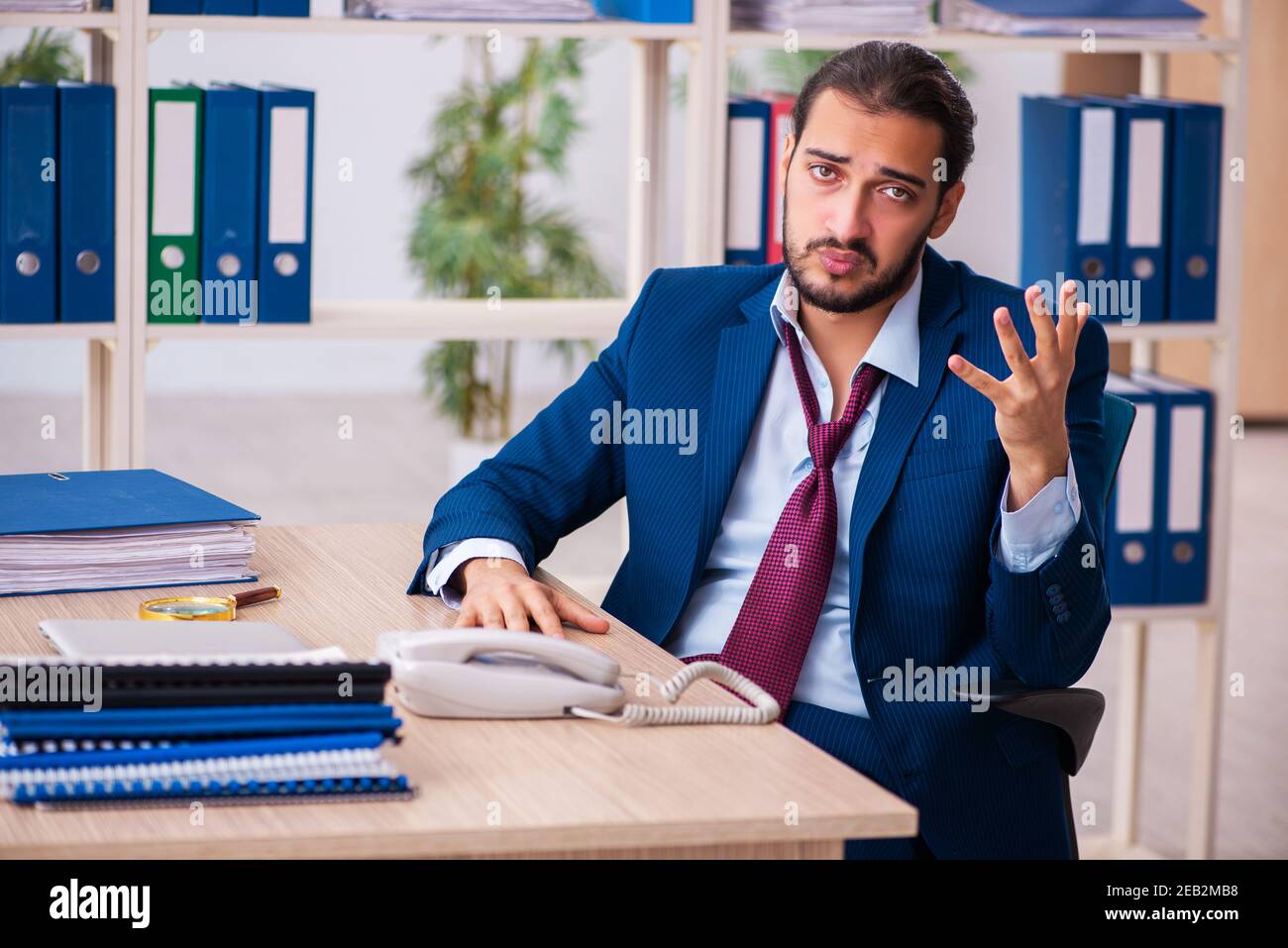 Young employee and too many work in the office Stock Photo - Alamy