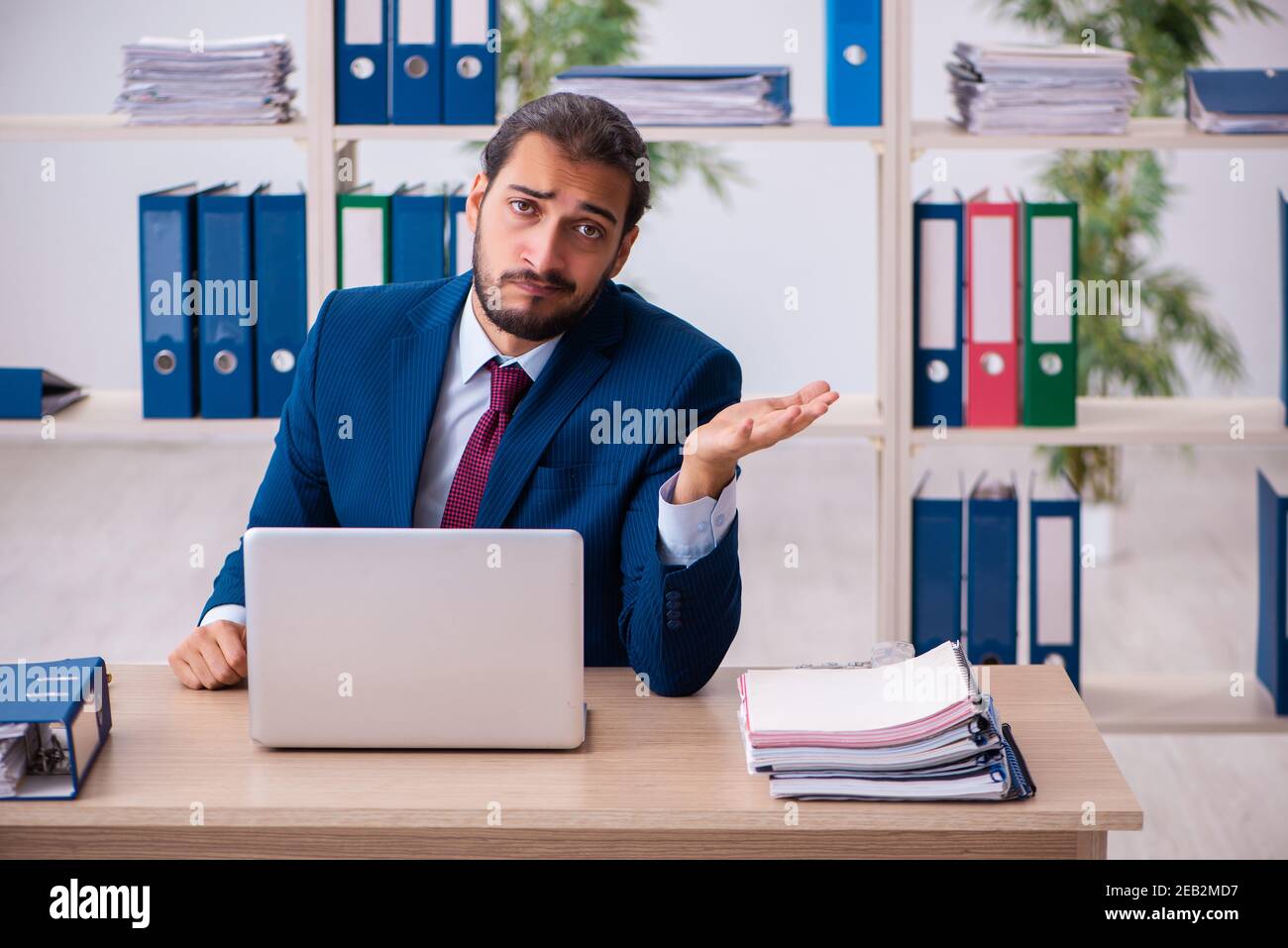 Young employee and too many work in the office Stock Photo - Alamy