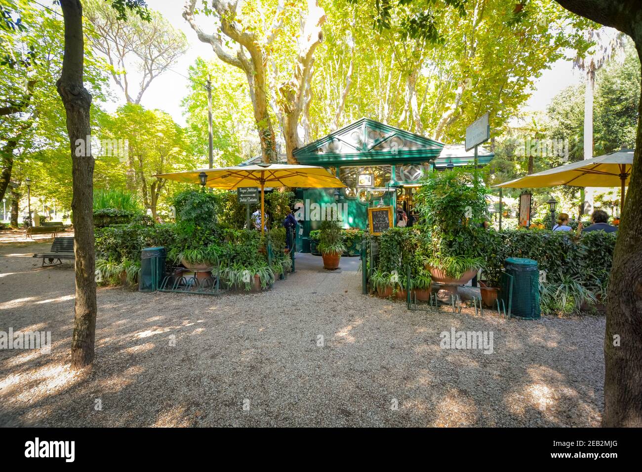 A picturesque, quaint cafe with garden and patio surrounded by trees and ivy in Villa Borghese Park in Rome, Italy Stock Photo