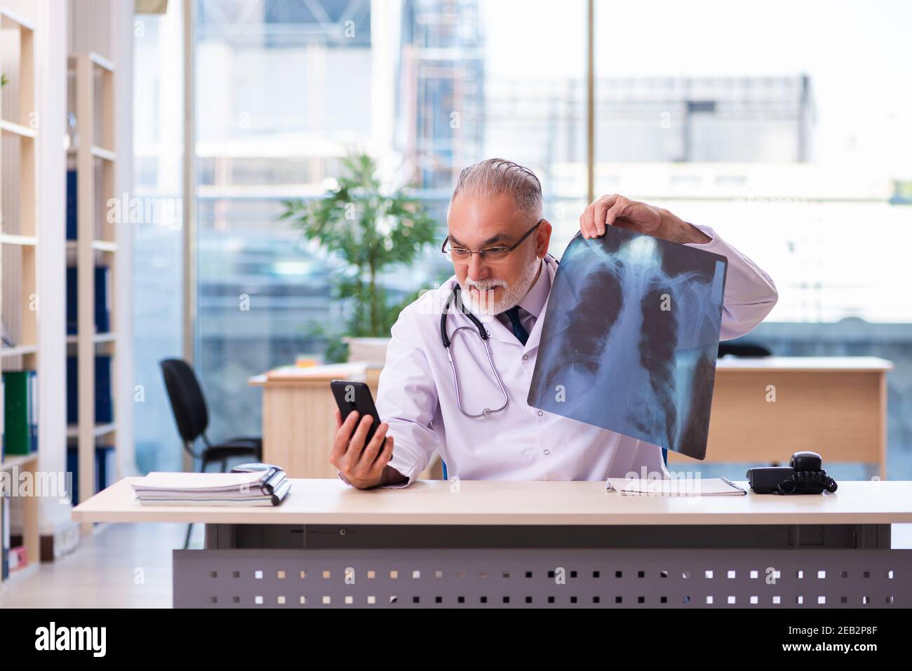 Old doctor radiologist working in the clinic Stock Photo - Alamy