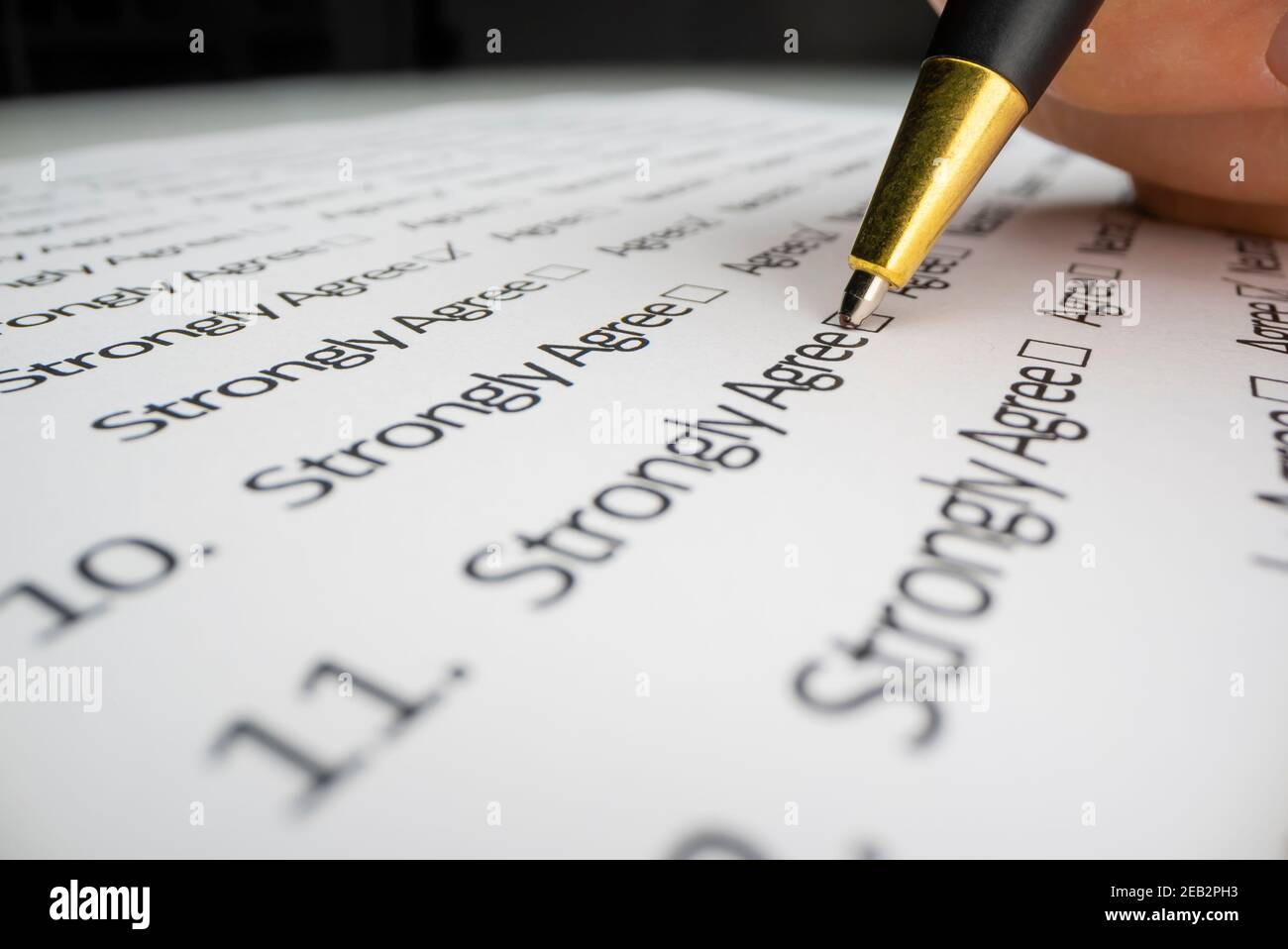 Close-up view of completing a questionnaire Stock Photo