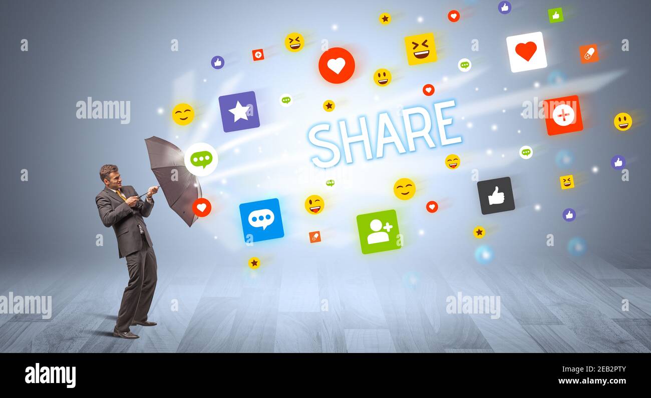 Handsome businessman defending with umbrella from SHARE inscription, social networking concept Stock Photo