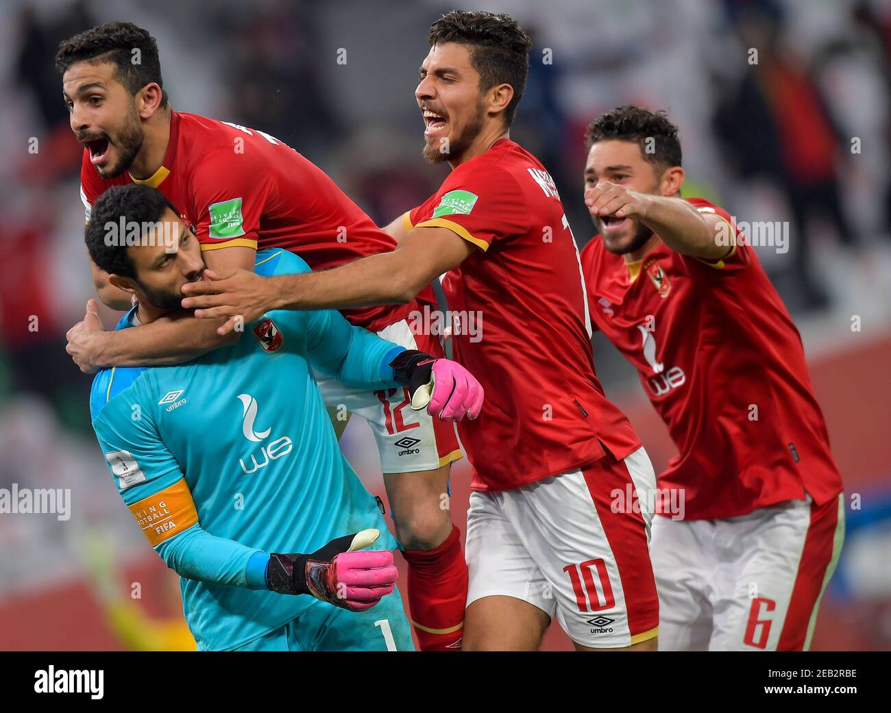 Doha, Qatar. 11th Feb, 2021. Al Ahly SC's goalkeeper Mohamed El-Shenawy (below L) and teammate Ayman Ashraf (above L), Mohamed Sherif (2nd R) celebrate after winning the penalty shoot-out of the FIFA Club World Cup 3rd place match between Egypt's Al Ahly SC and Brazil's SE Palmeiras at the Education City Stadium in Doha, Qatar, Feb. 11, 2021. Credit: Nikku/Xinhua/Alamy Live News Stock Photo