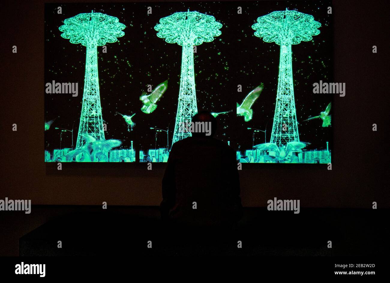 A man watches a video exhibit at the New York Museum of Modern Art ...
