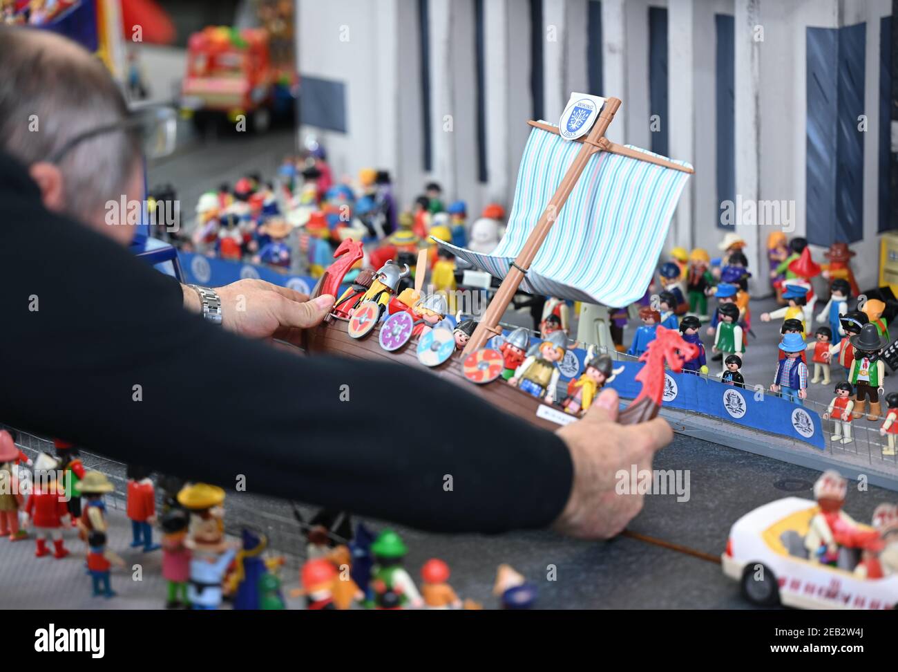 11 February 2021, Hessen, Offenbach/Main: Playmobil figures and miniature  themed floats represent a carnival procession in a recreated setting.  Passionate hobbyists from the Offenbacher Karnevalverein (OKV) have spent  weeks of painstaking work