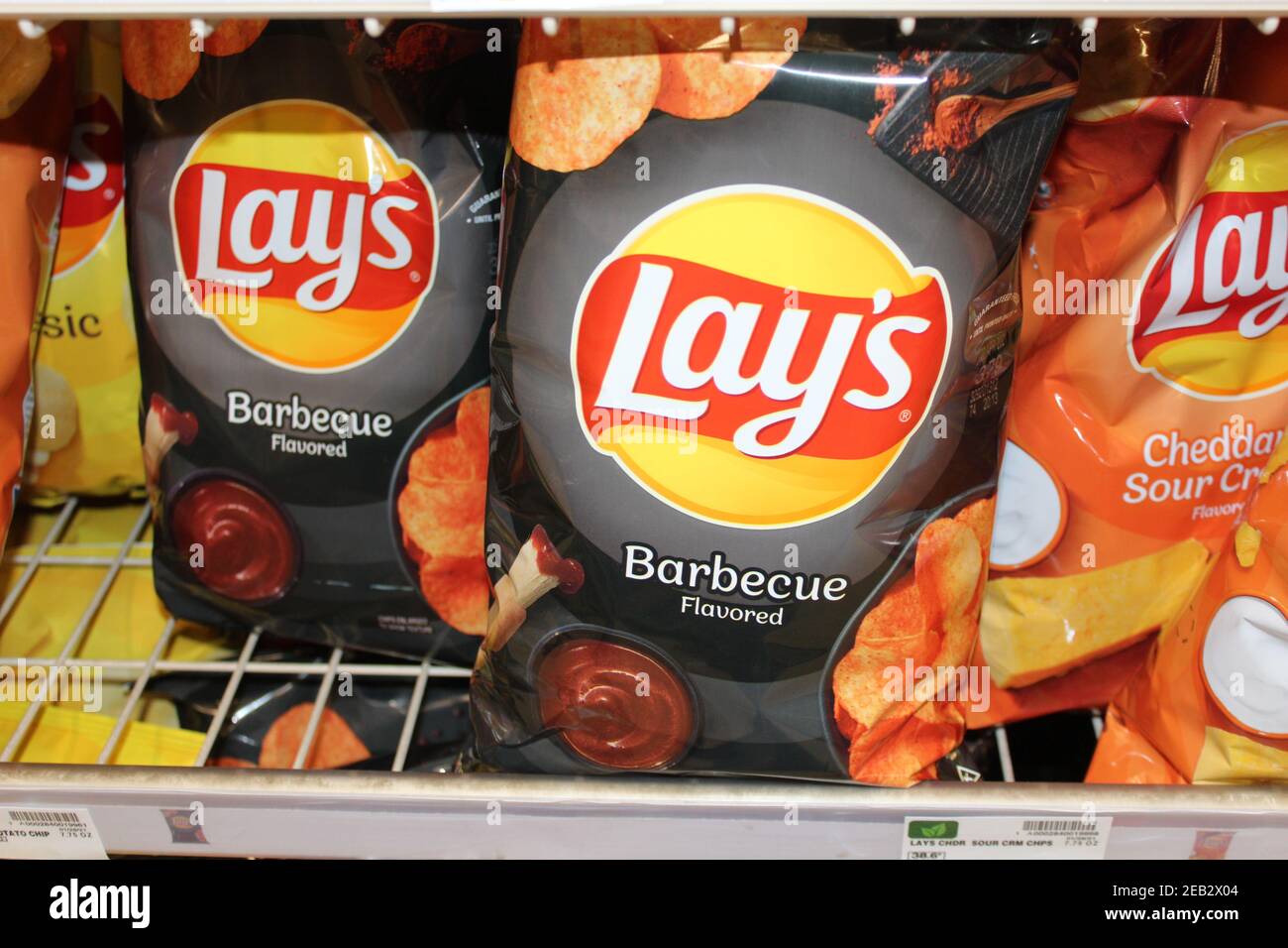 Lays Barbeque chips shot closeup on a metal shelf at a grocery store in