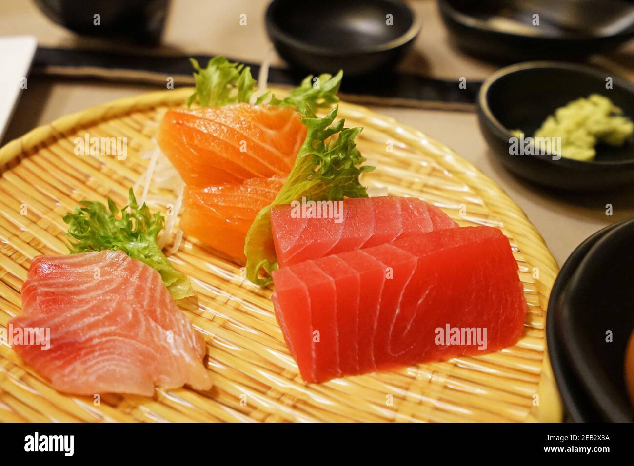 Close up Assorted Sashimi served on wooden dish Salmon, Tuna and
