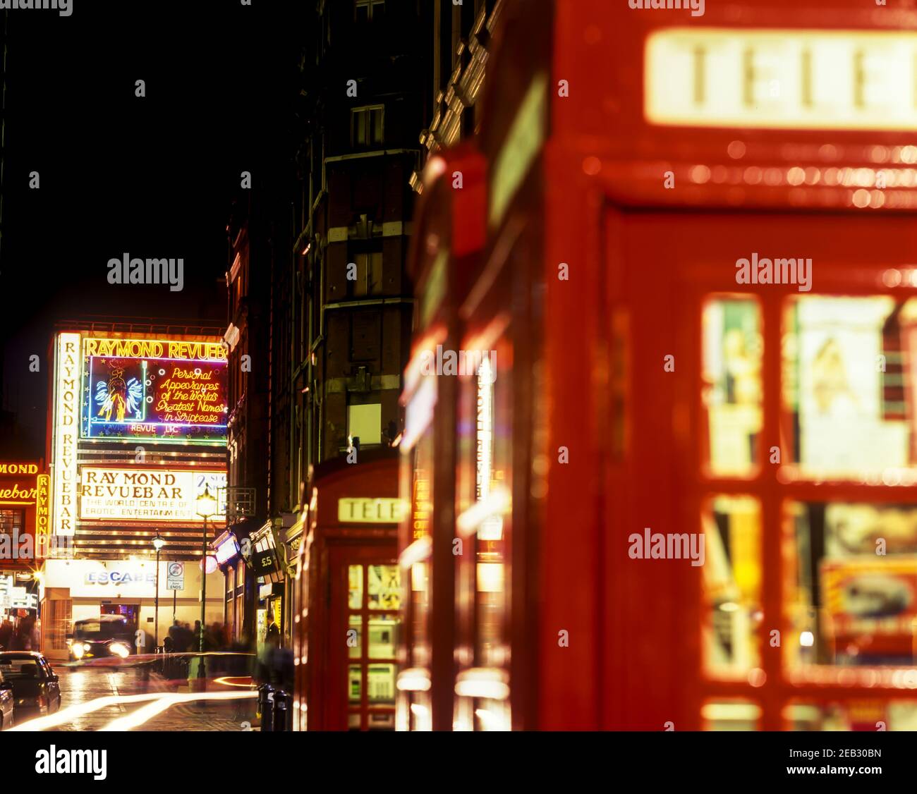 2000 HISTORICAL ROW OF RED KIOSK No.6 TELEPHONE BOXES RAYMOND REVUE BAR DENMAN STREET SOHO LONDON ENGLAND UK Stock Photo