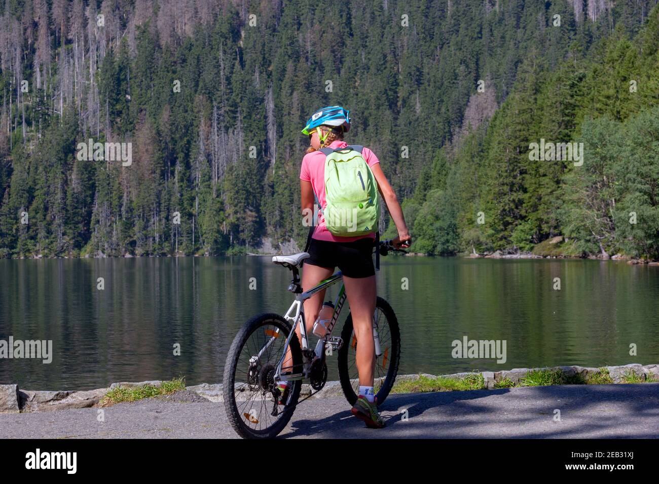 Bicycle woman on a trip with backpack Sumava National Park Czech Republic Black Lake - Cerne Jezero, shore, bike Stock Photo