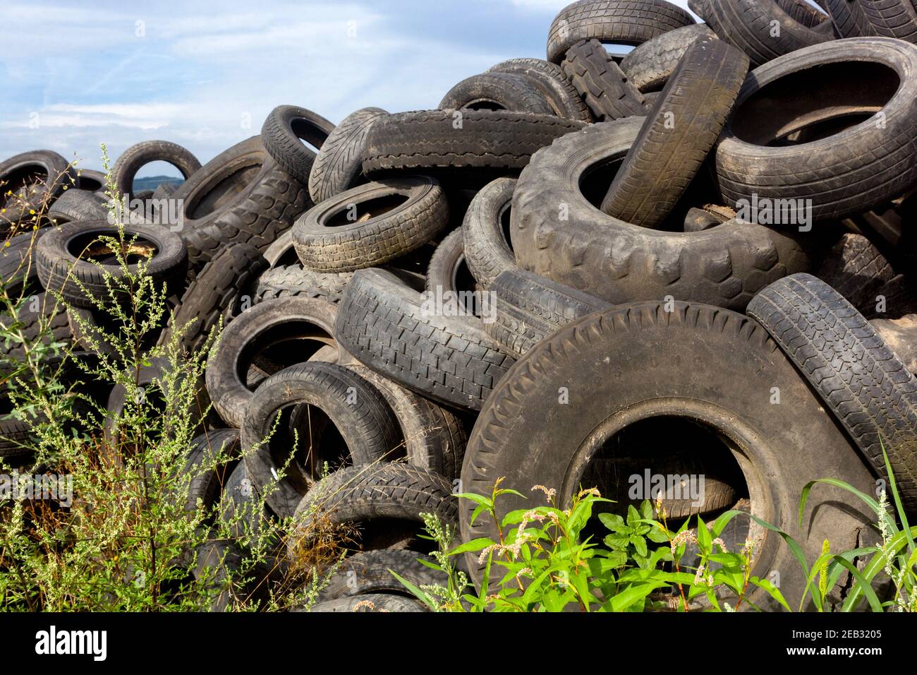 Old tires garbage depot rubbish car tires used waste heap trash dumped Stock Photo