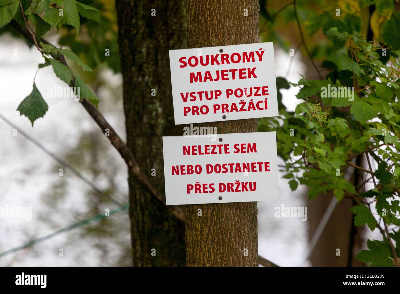 Signs warning unwelcome visitors to the owner's private property, Czech Republic, Czech inscription Stock Photo