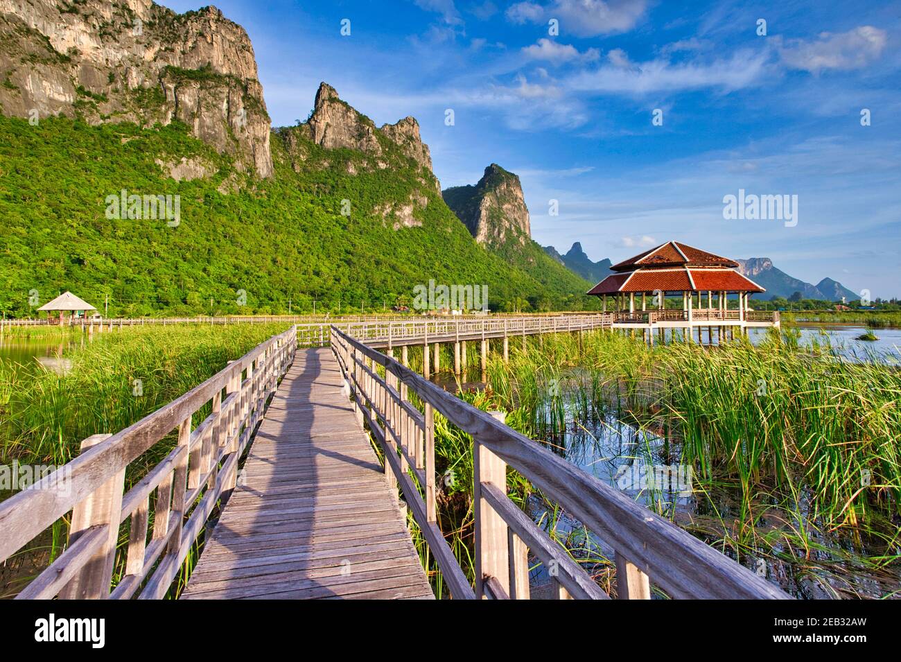 Wooden bridges and small pavilions with mountain views. There is a blue sky in the evening at Lotus Pond is a national park in Sam Roi Yot District, P Stock Photo