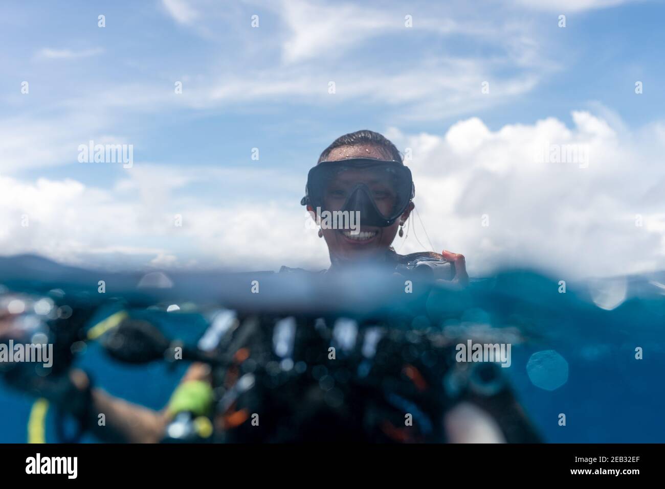 Scuba diving girl in blue ocean open water and blue sky Stock Photo - Alamy