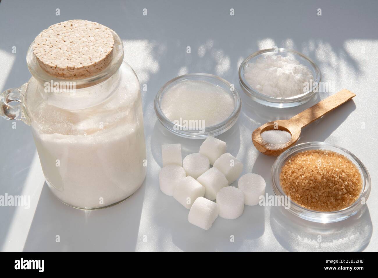 Different kinds of sugars in containers and spoons Stock Photo Alamy