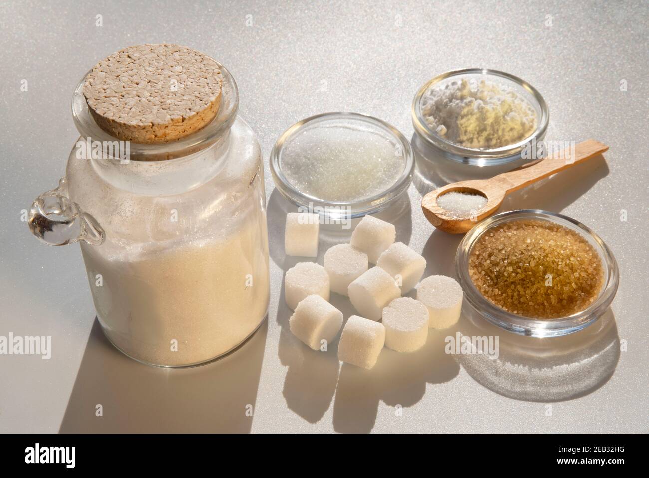 Different kinds of sugars in containers and spoons Stock Photo Alamy