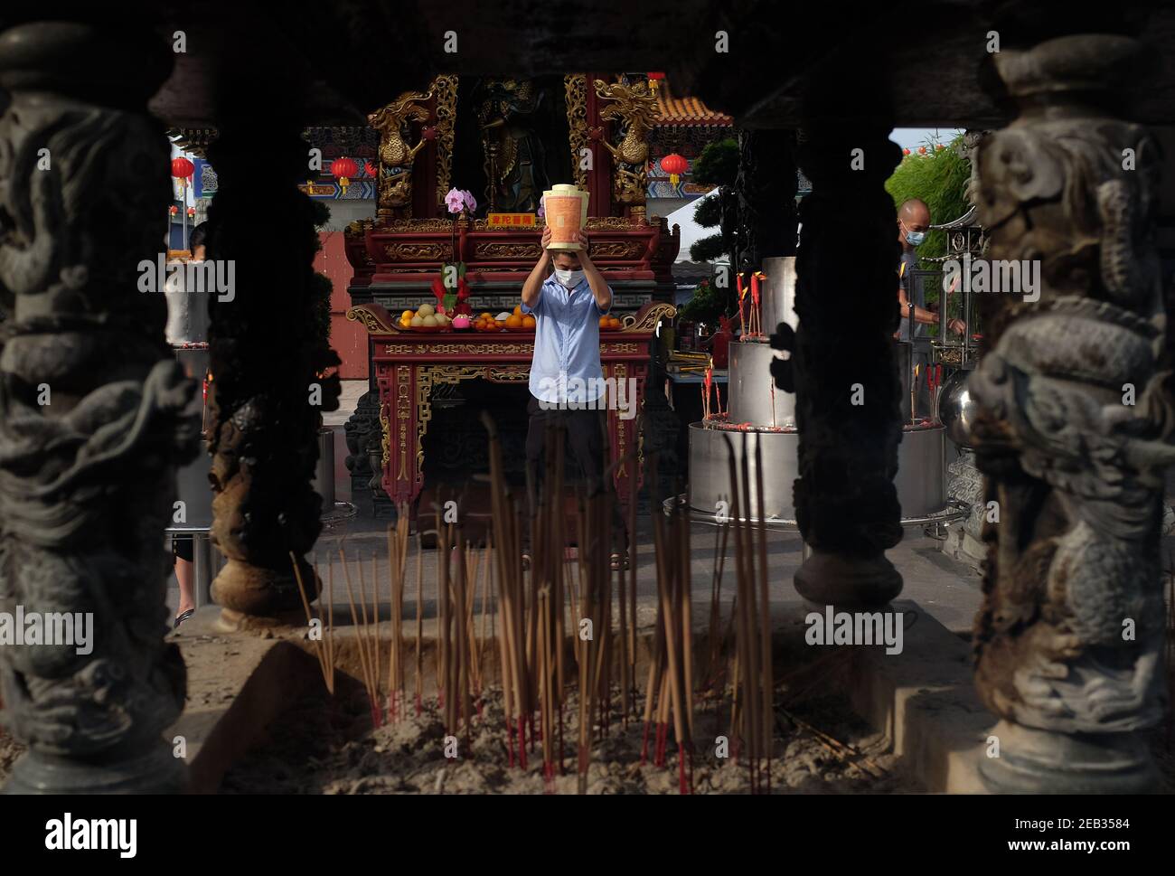 Klang, Selangor, Malaysia. 12th Feb, 2021. A man offer prayers before burn the incense paper in the temple during Chinese New Year. The Chinese Lunar New Year on February 12 will welcome the Year of the Ox. Credit: Kepy/ZUMA Wire/Alamy Live News Stock Photo
