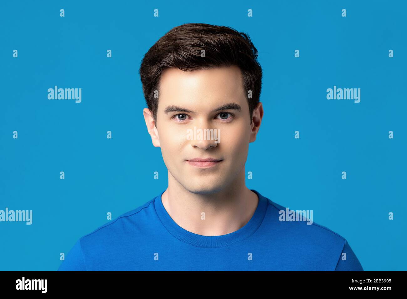 Isolated studio portrait of handsome caucasian man in blue plain t-shirt Stock Photo