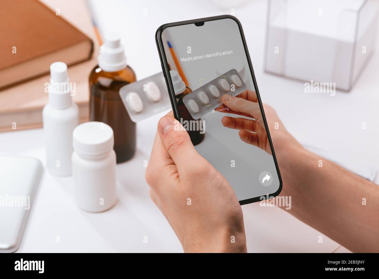 Man using a phone app to recognize unknown pills Stock Photo