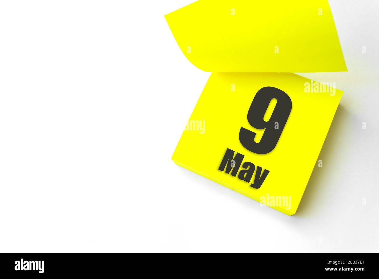 May 9th. Day 9 of month, Calendar date. Close-Up Blank Yellow paper reminder sticky note on White Background. Spring month, day of the year concept Stock Photo