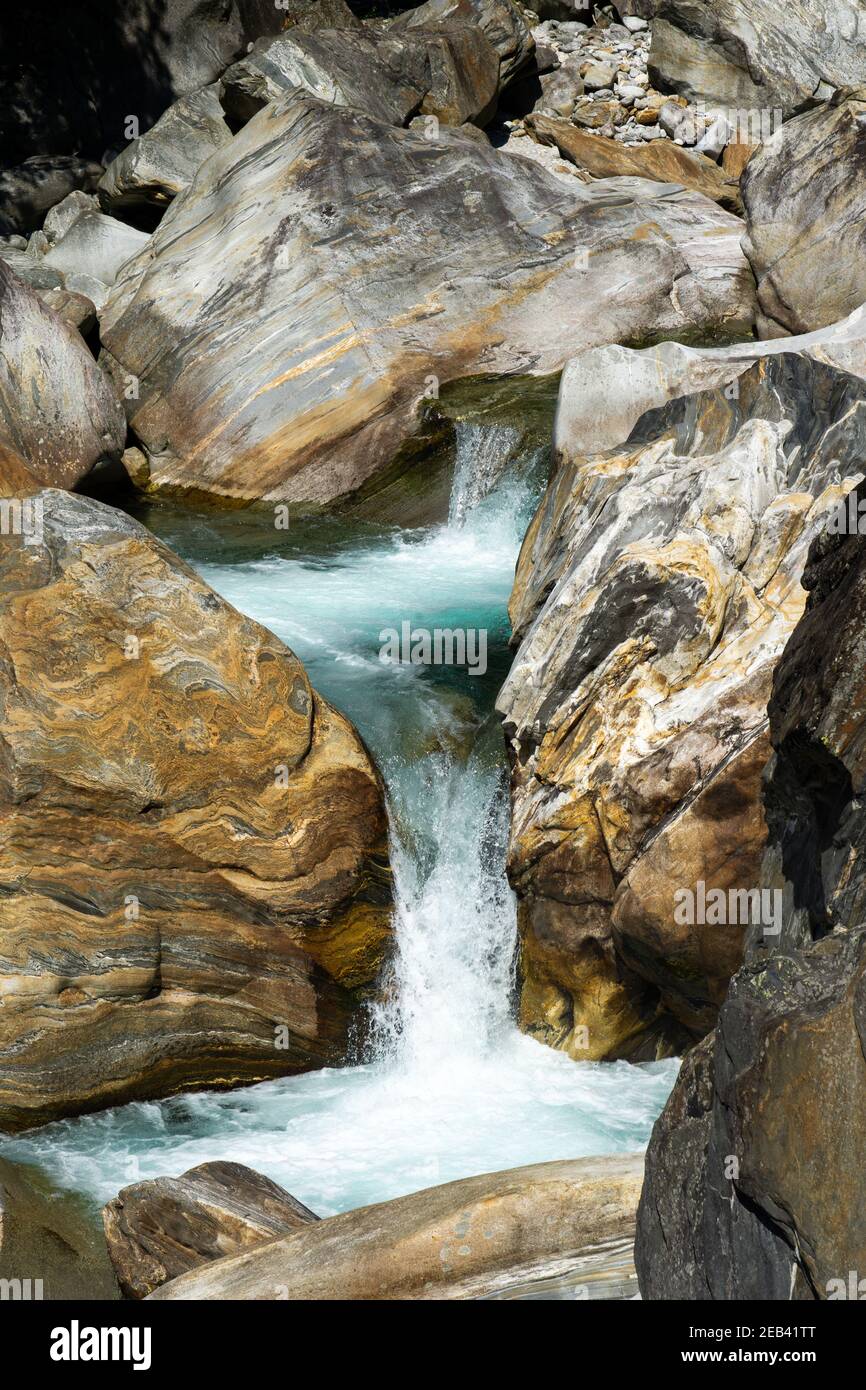 A large waterfall over a rocky cliff at Verzasca valley in Siwtzerland Stock Photo