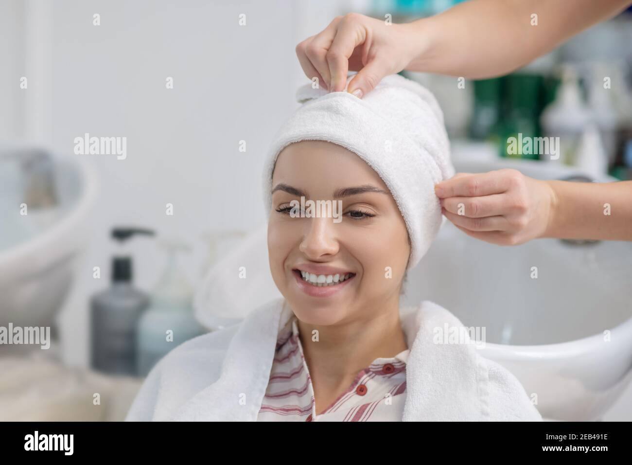 Hairdresser covering her customers hair with a towel Stock Photo Alamy