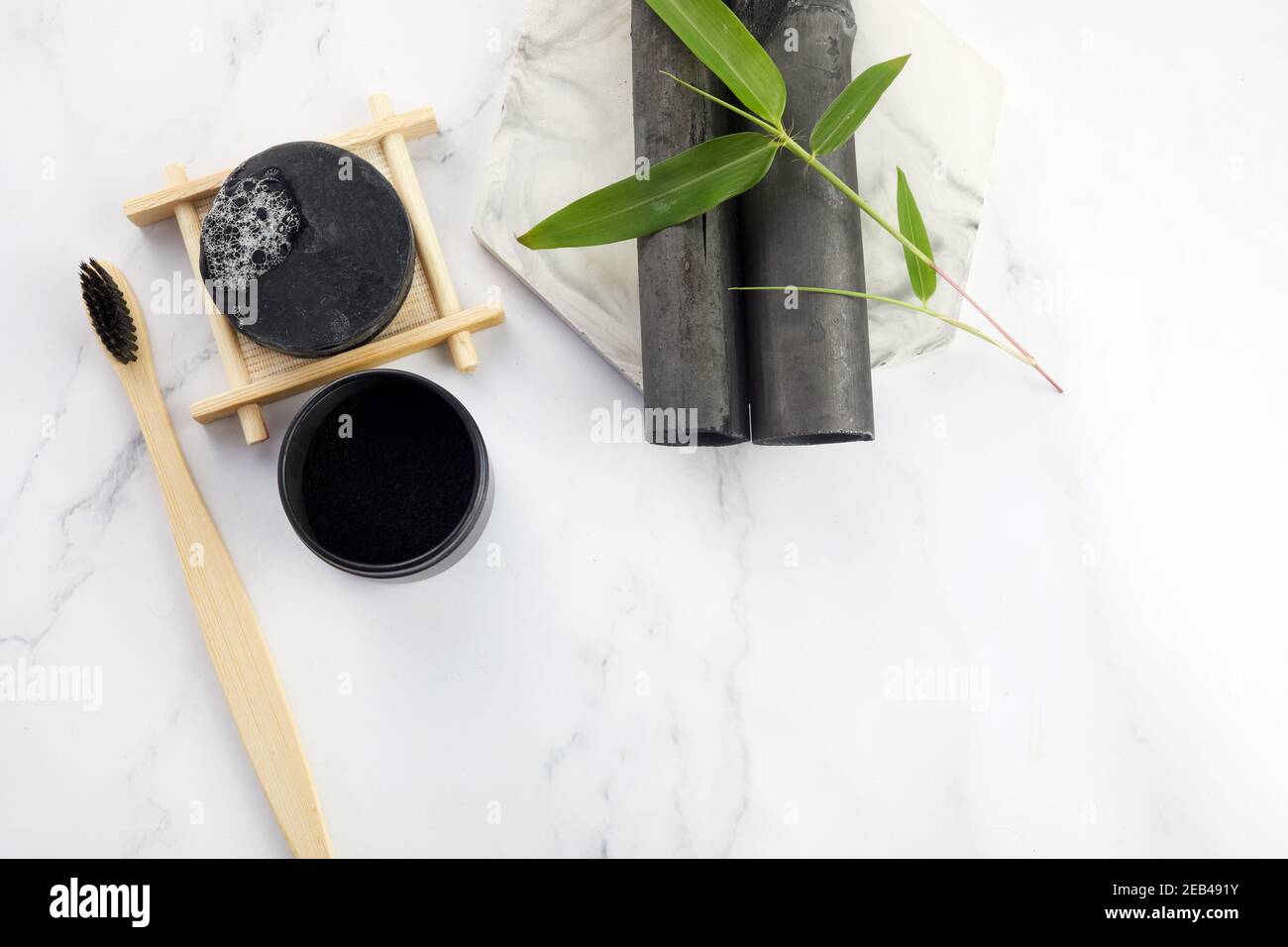 Activated Bamboo charcoal tooth powder on marble background. Stock Photo