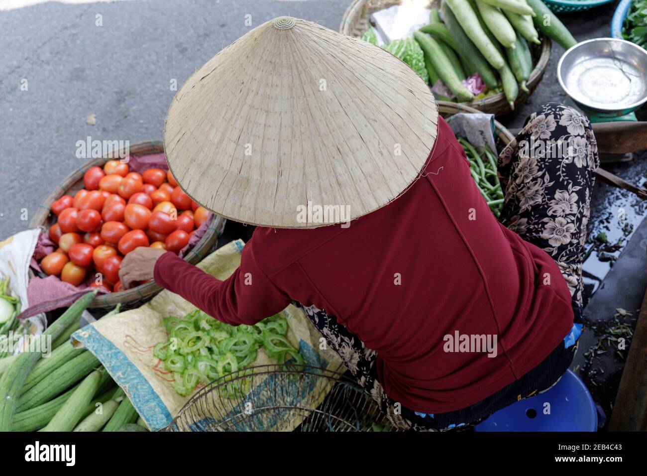 A Vietnamese woman selling vegetables in Hoi An, Vietnam. Stock Photo