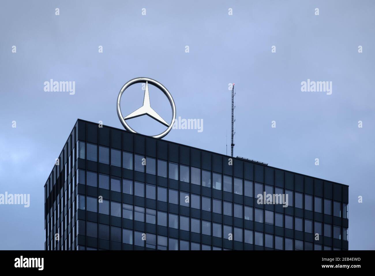 Mercedes-Benz rotating logo over the rooftop of the headquarter in Breitscheidplatz, Berlin, Germany Stock Photo
