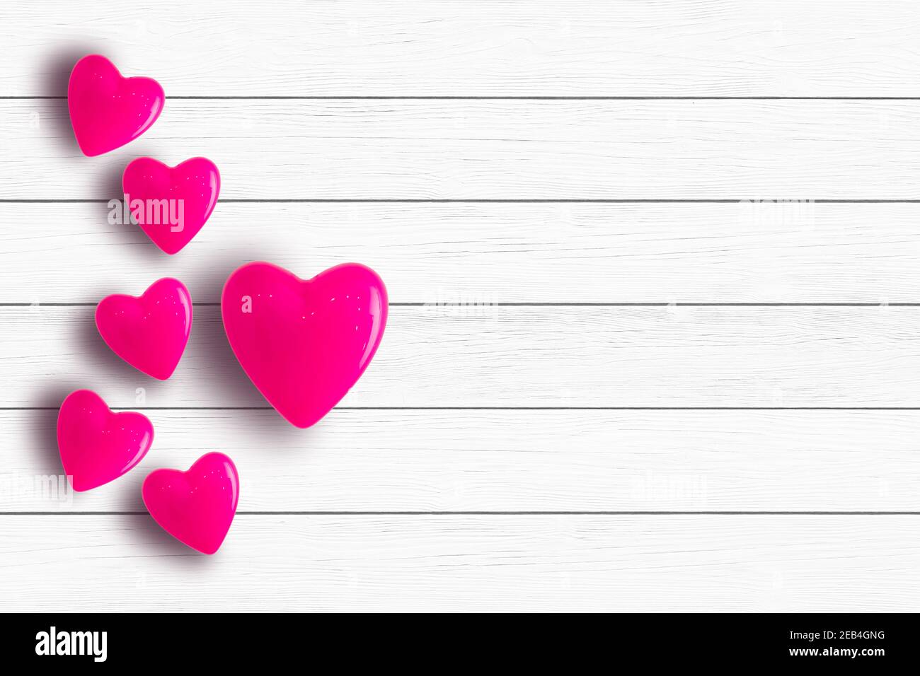 Valentine's day background with red hearts on wooden planks Stock Photo ...