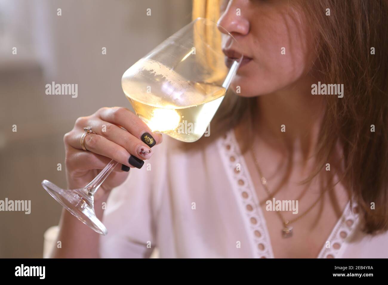 Girl drinking white wine Stock Photo Alamy