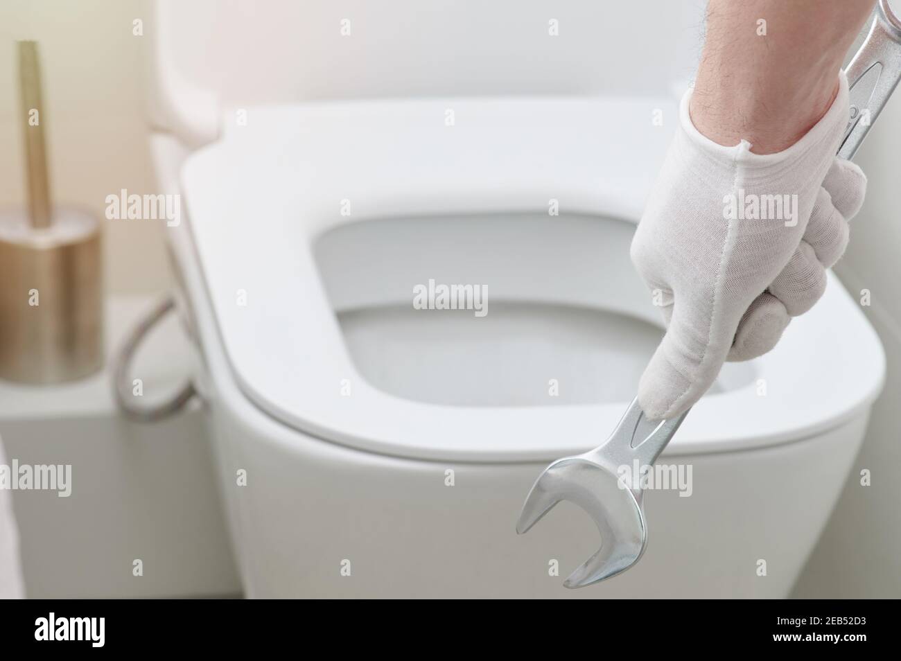 Hand hold wrench tool on toilet seat background Stock Photo Alamy