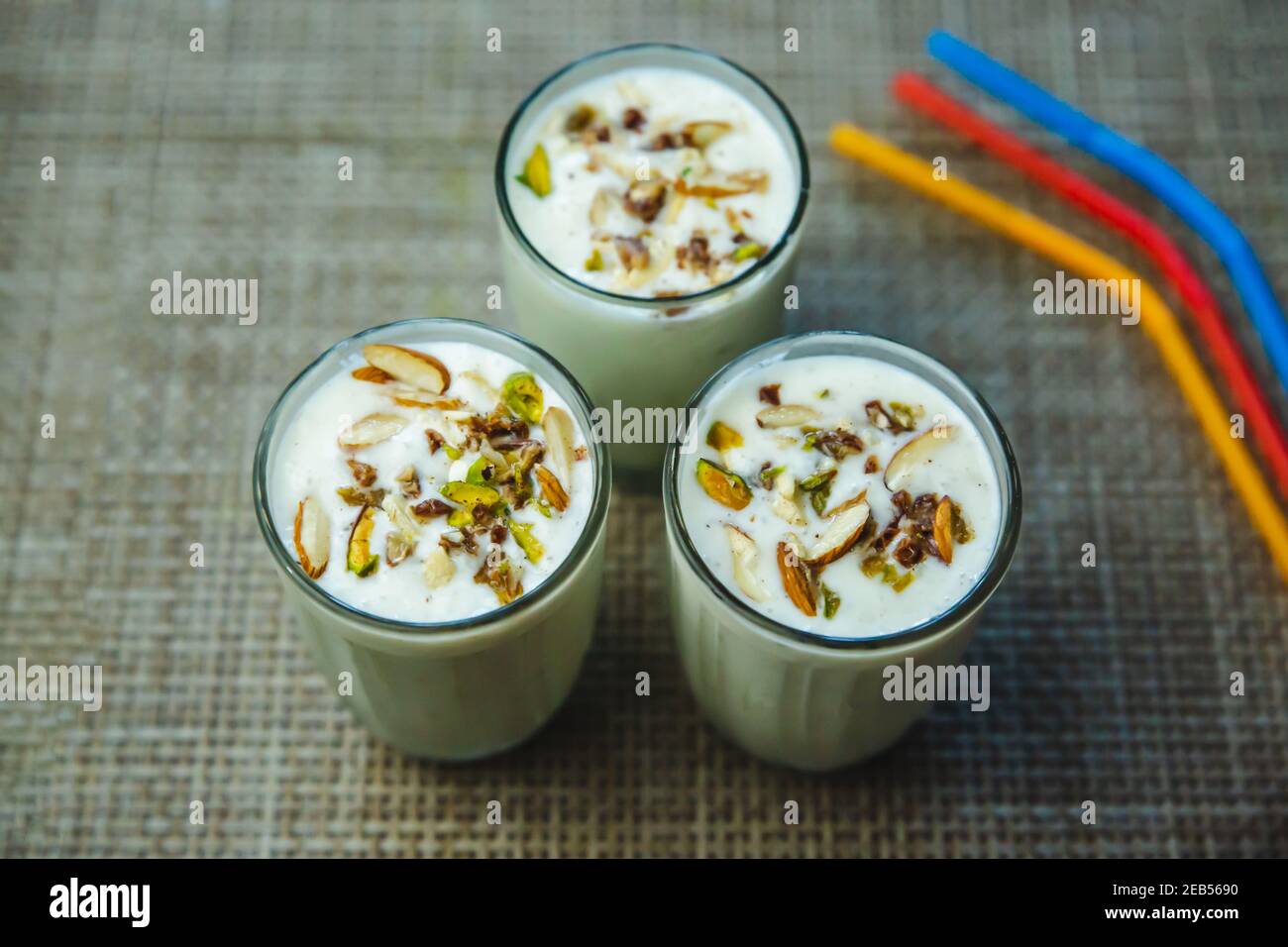 Delicious Banana Milkshakes with Nuts and straws on the table. cold
