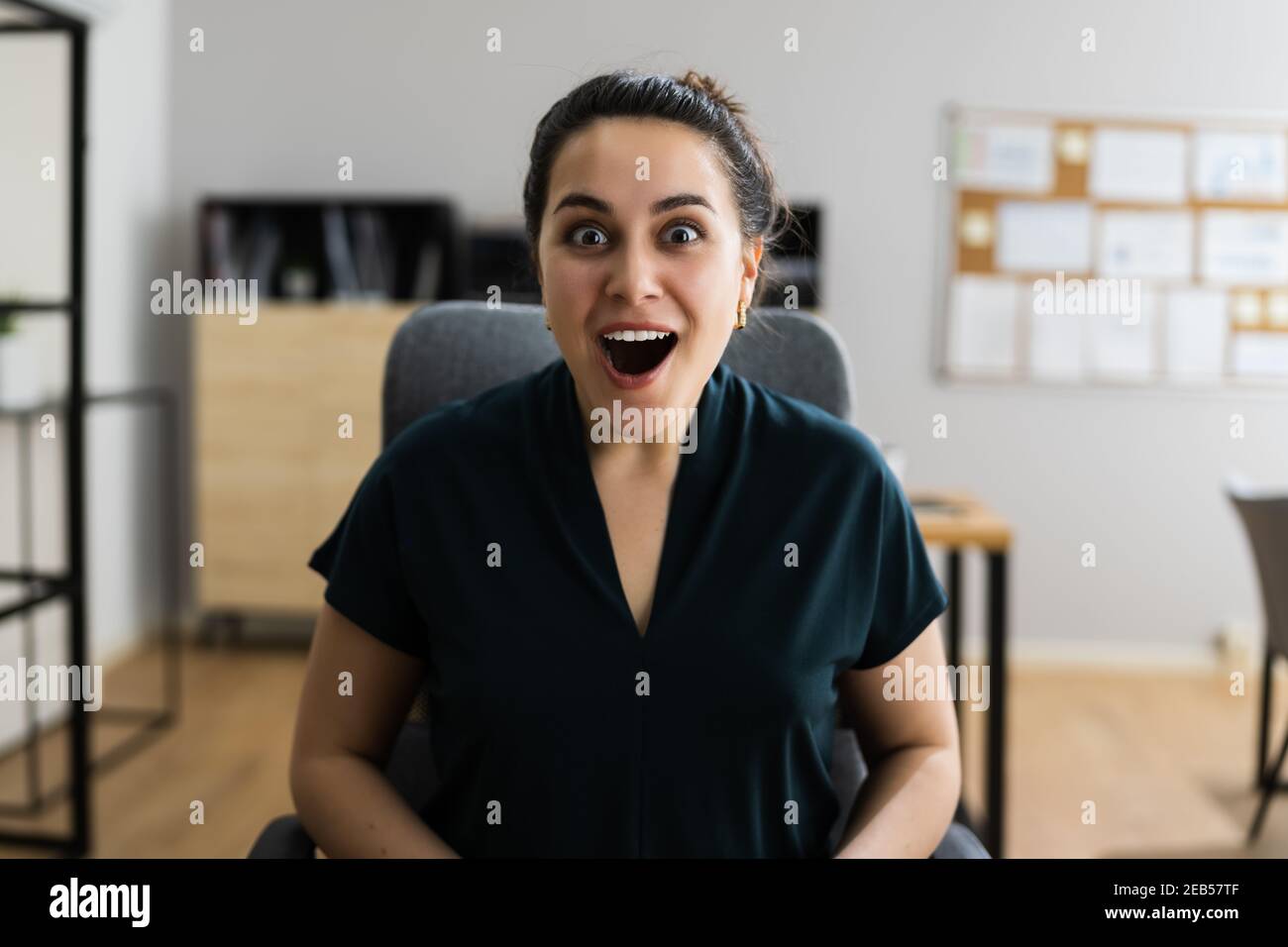 Excited Happy Employee Woman Headshot In Office Stock Photo
