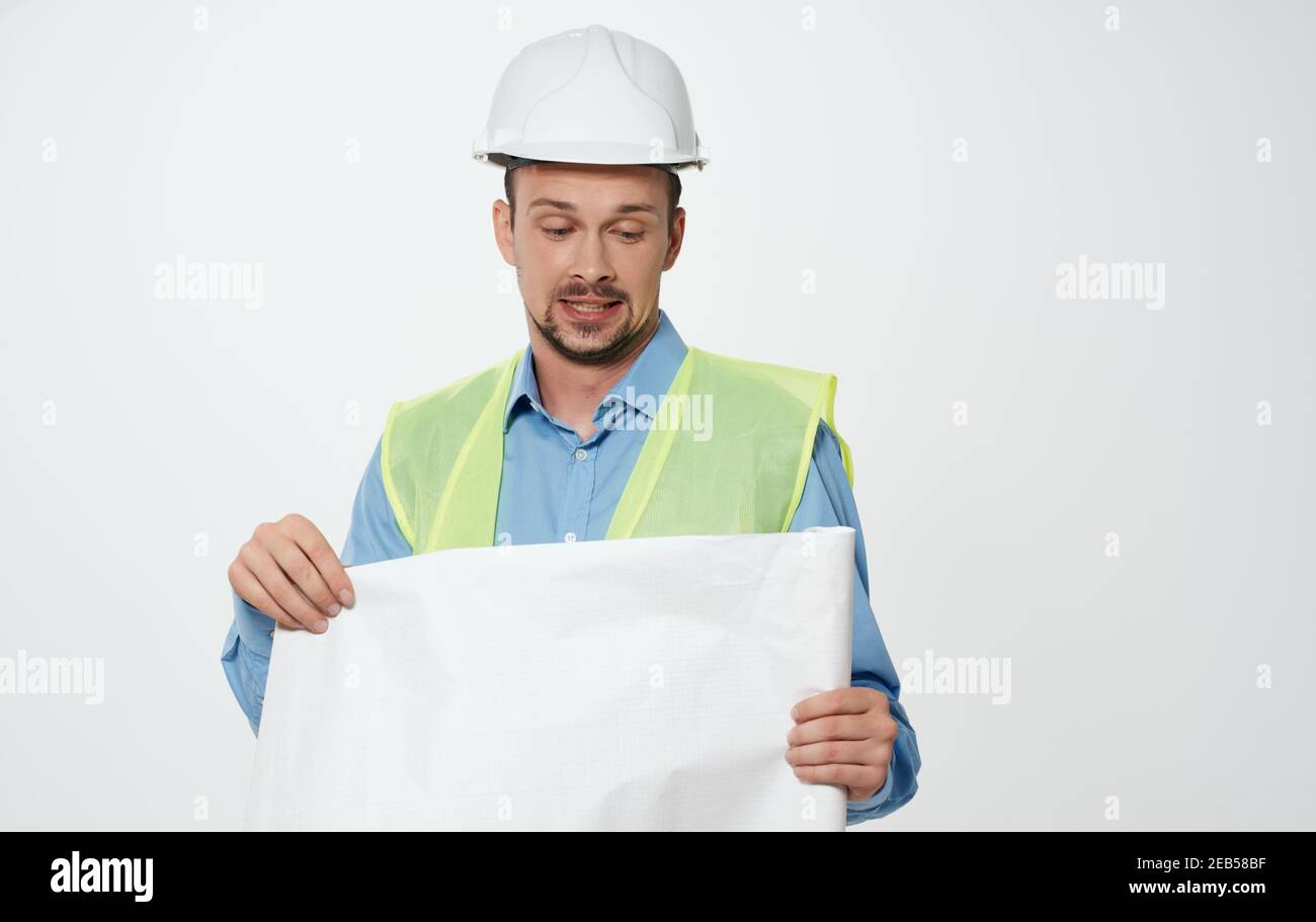 A male civil engineer with a roll of 