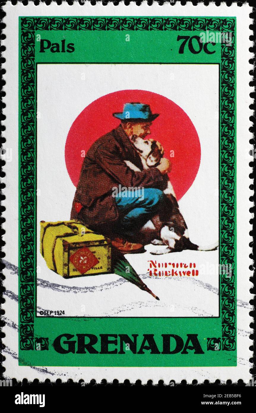 Tramp hugging a dog in illustration by Rockwell on stamp Stock Photo