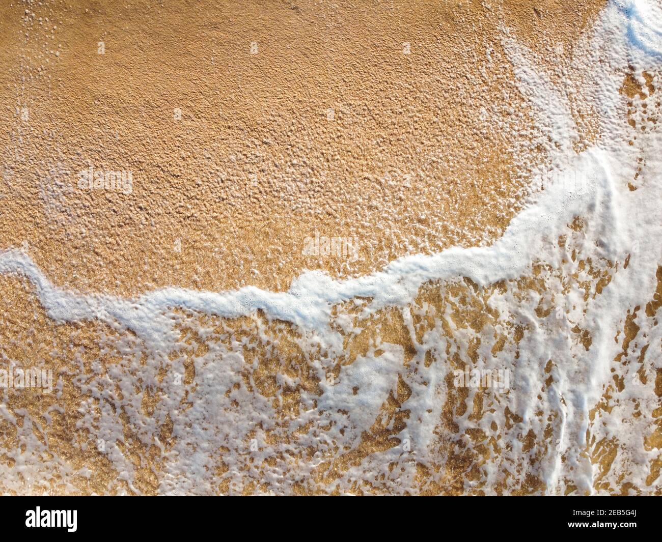 Foam from the sea wave on the sand Stock Photo - Alamy