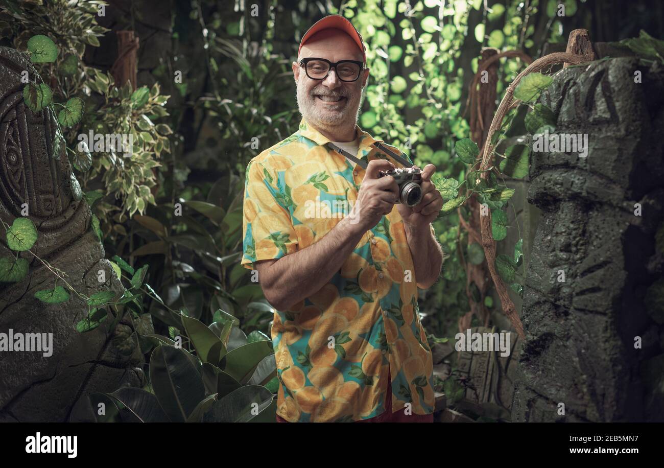 Funny happy tourist exploring the jungle and taking pictures with his ...