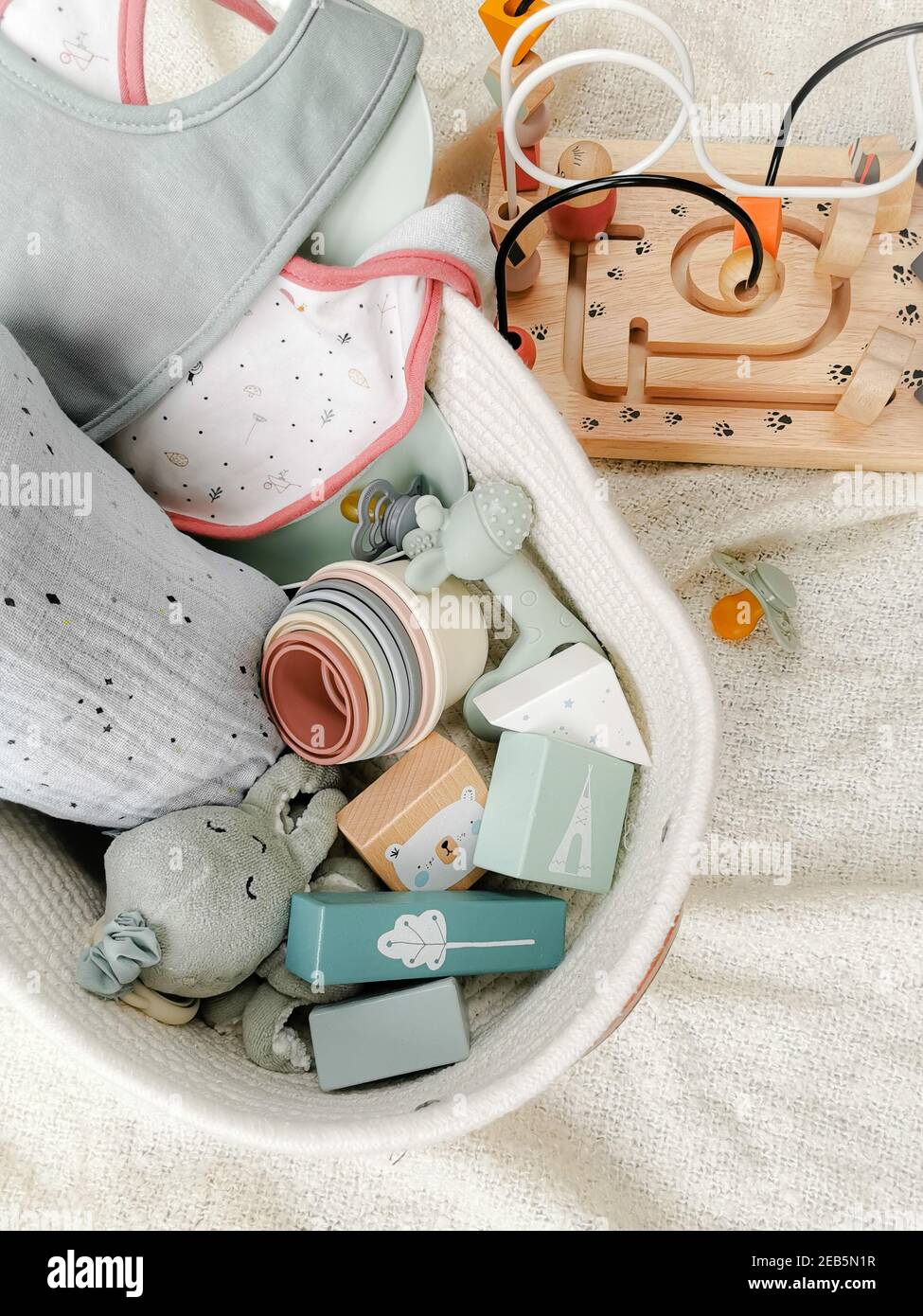 Gender neutral gift set for a baby shower with toys in soft colors. Flay Lay. Gender-neutral parenting. Stock Photo