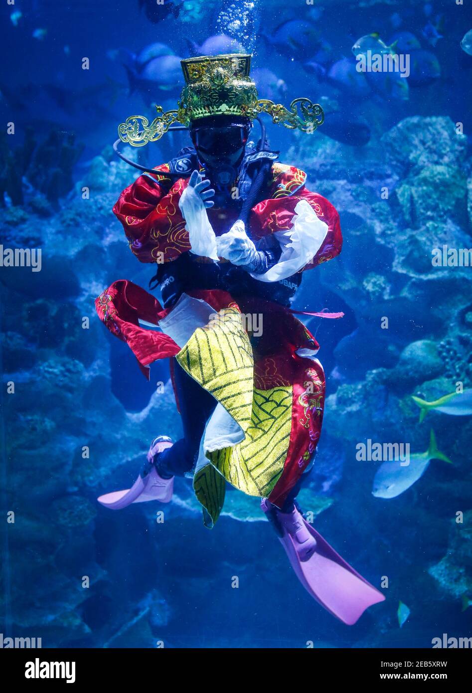 Kuala Lumpur, Malaysia. 12th Feb, 2021. A diver dressed as God of Fortune performs at the Aquaria KLCC during the Lunar New Year celebrations.Chinese around the world will be celebrating the Chinese Lunar New Year and welcome the year of Ox which falls on February 12, 2021. Credit: SOPA Images Limited/Alamy Live News Stock Photo