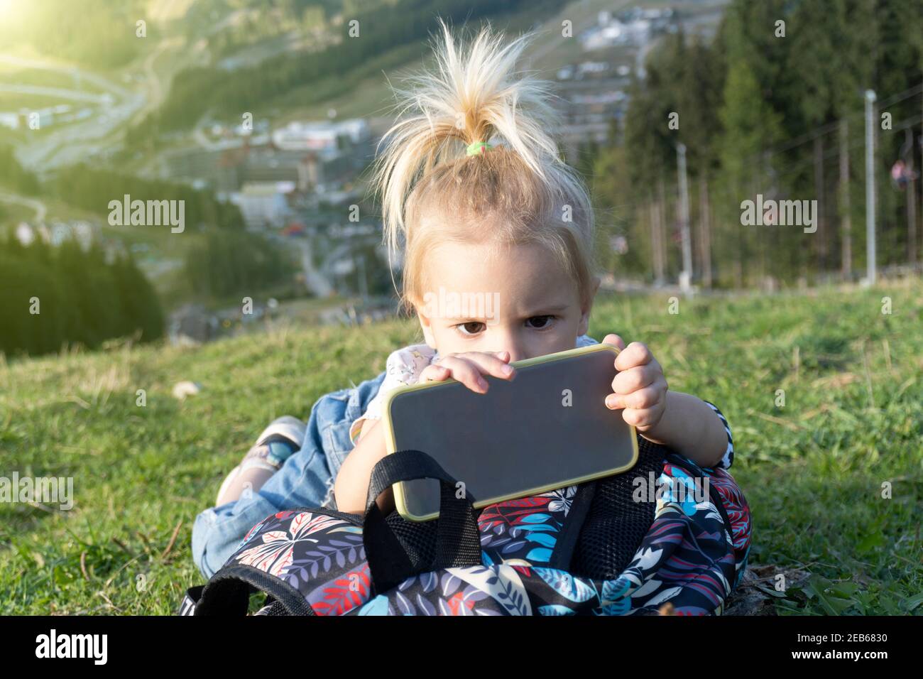 Young child looking at phone Stock Photo