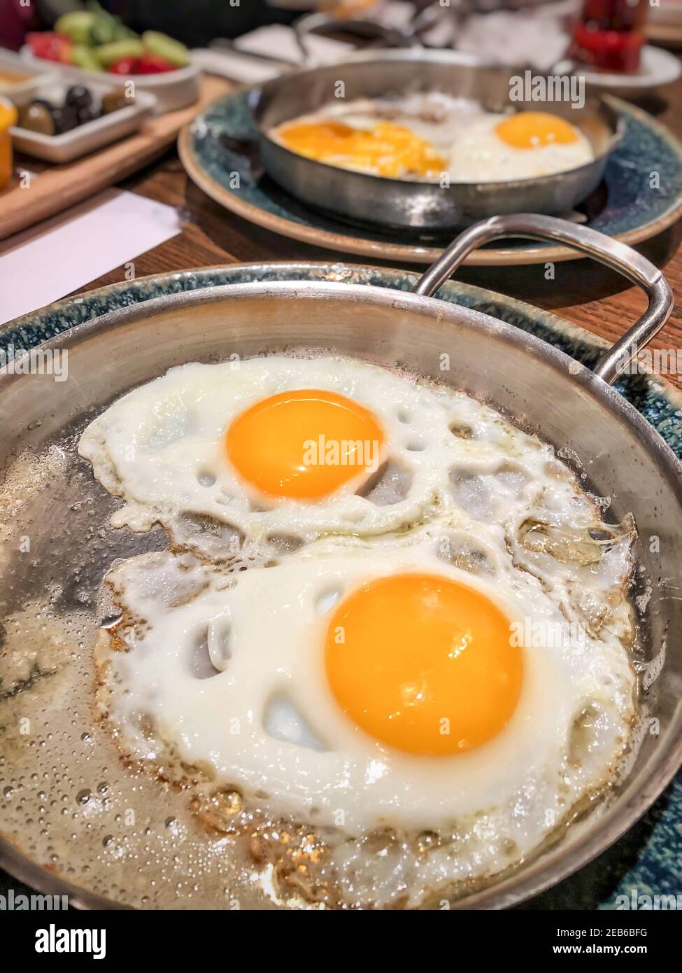 closeup fried eggs in pan for breakfast served on the table Stock Photo